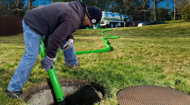Service technician performing residential septic pumping and drainage maintenance in Louisville, KY